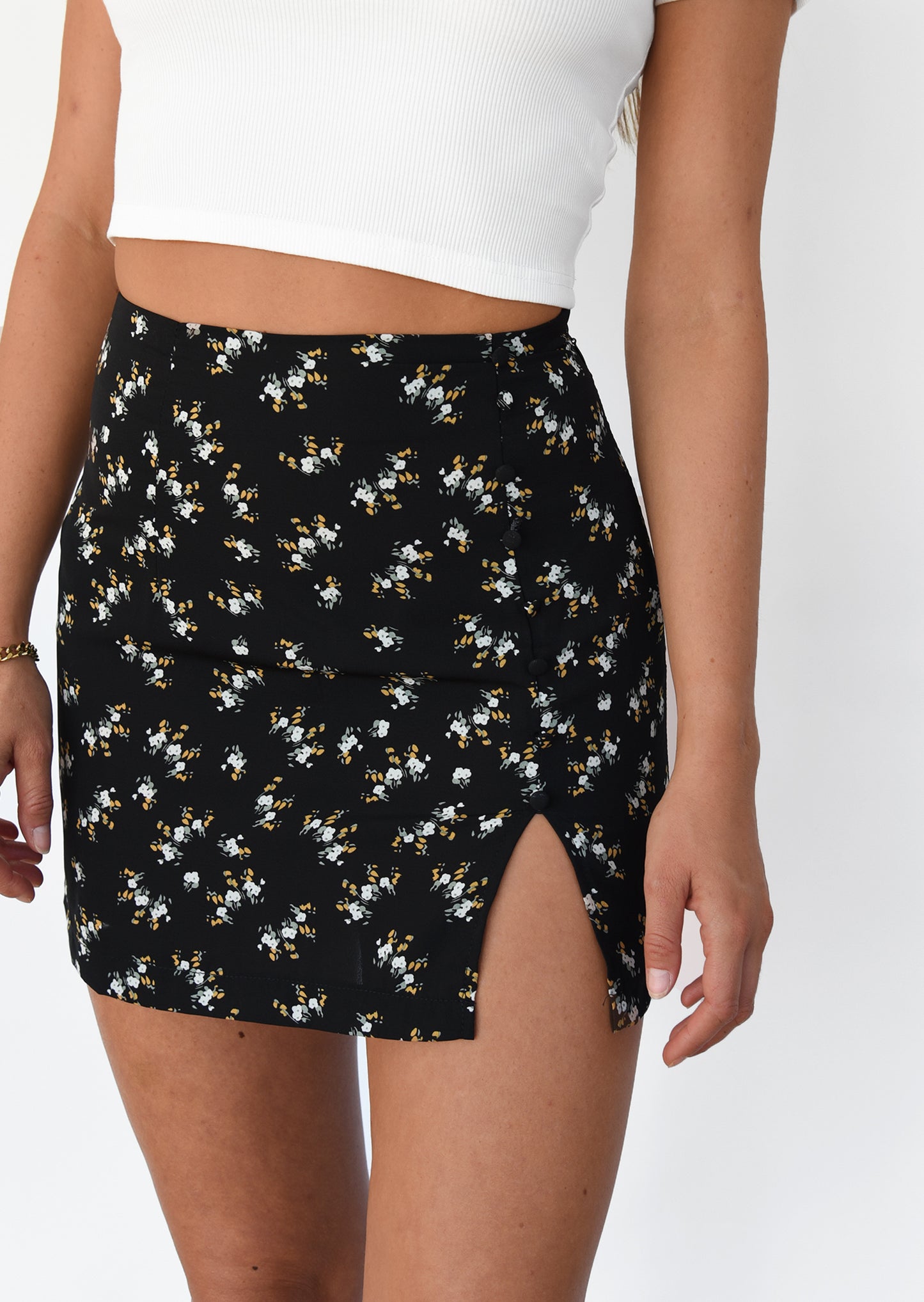 Black floral mini skirt with front split and buttons details
