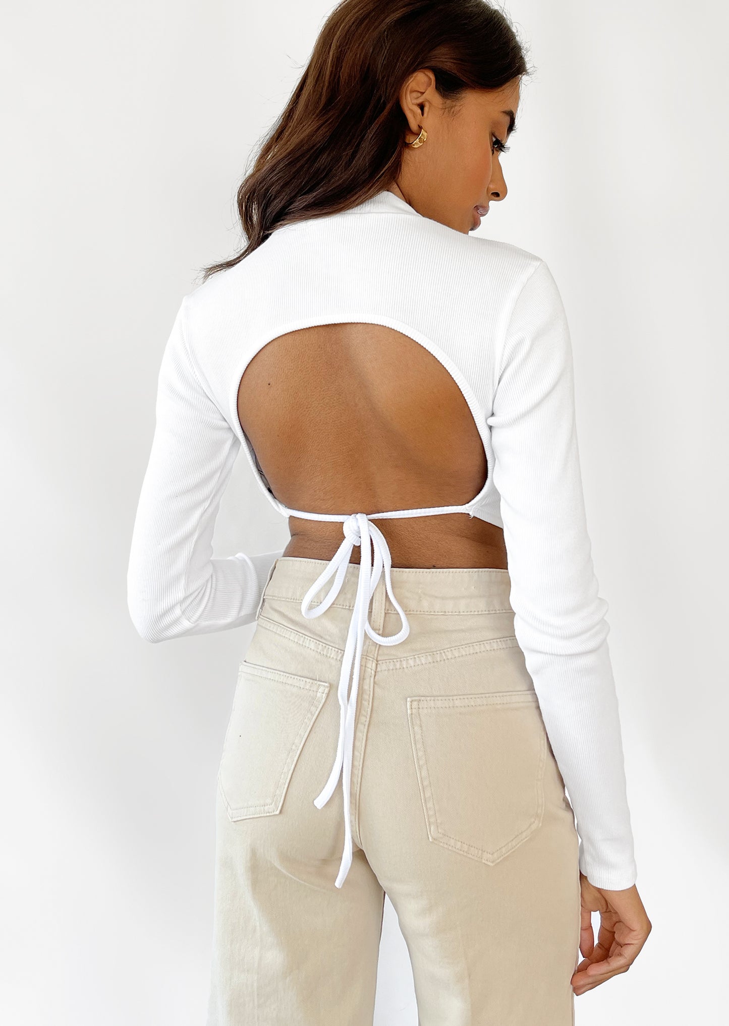 Open back long sleeve top with scarf hem in white