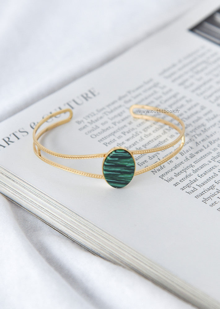 Gold tone cuff bracelet with green stone